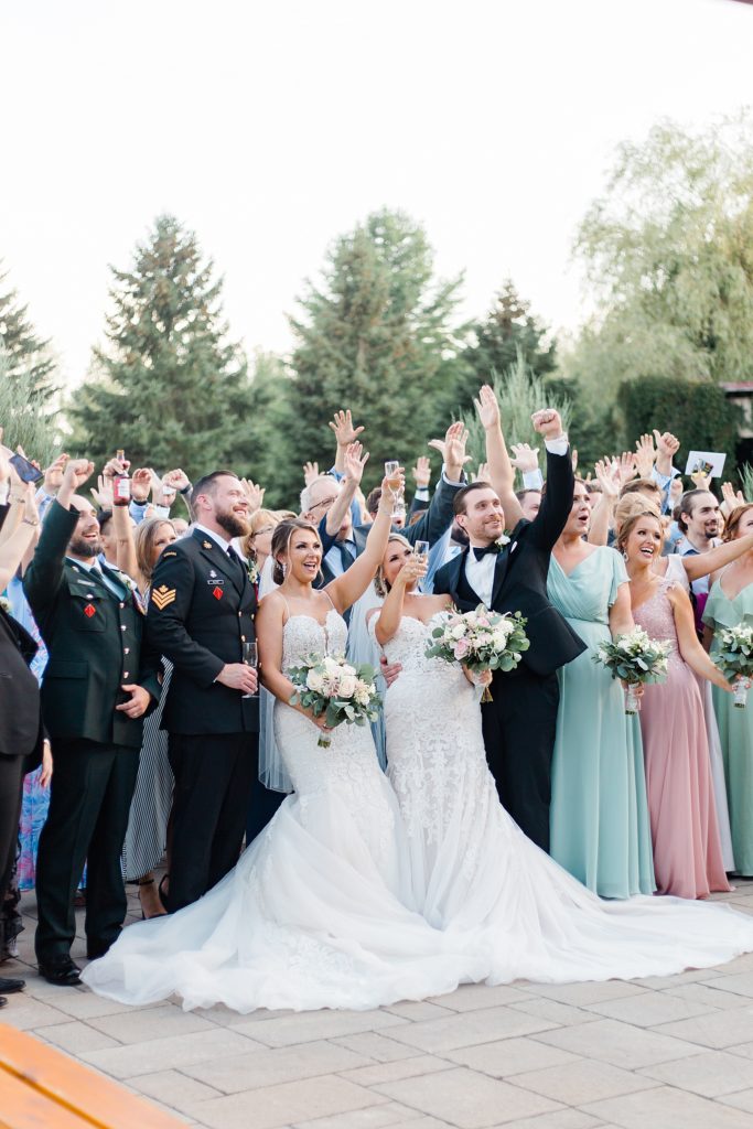 group cheering after both couples got married at bean town ranch double wedding photographed by Brittany Navin Photography