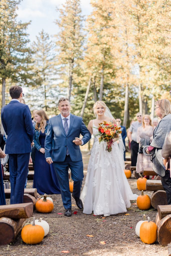 bride and father coming down the aisle at Calabogie Peaks wedding photographed by Brittany Navin Photography