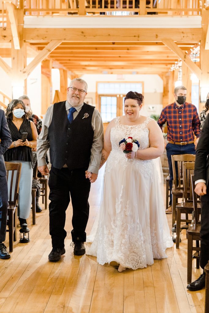 bride coming down the aisle with her dad during the ceremony at temples sugar bush wedding photographed by Brittany Navin Phtoography