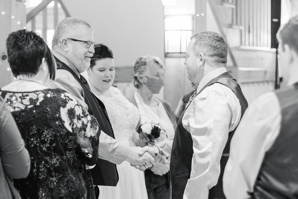 father of the bride shaking grooms hand during ceremony at temples suagr bush wedding photographed by Brittany navin Photography