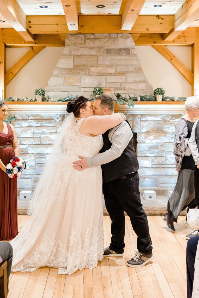 bride and groom first kiss at temples sugar bush wedding photographed by Brittany Navin Photography