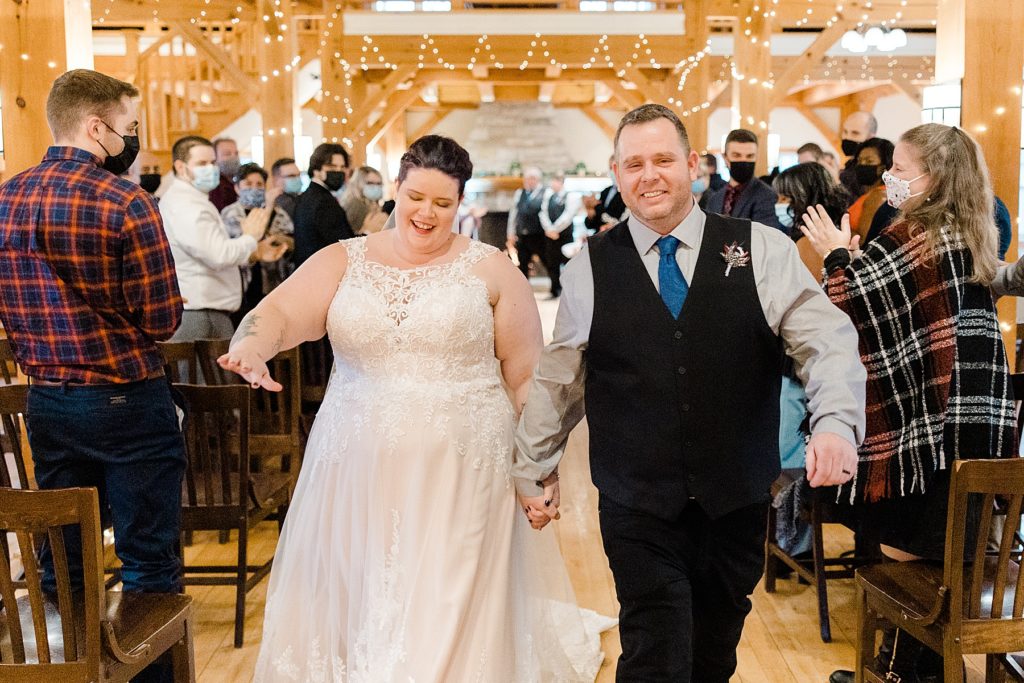 bride and groom coming back down the aisle at temples sugar bush wedding photographed by Brittany Navin Photography