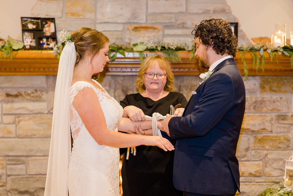 hand fasting during ceremony with officiant Angela Giles at for temples country winter wedding photographed by Brittany Navin Photography