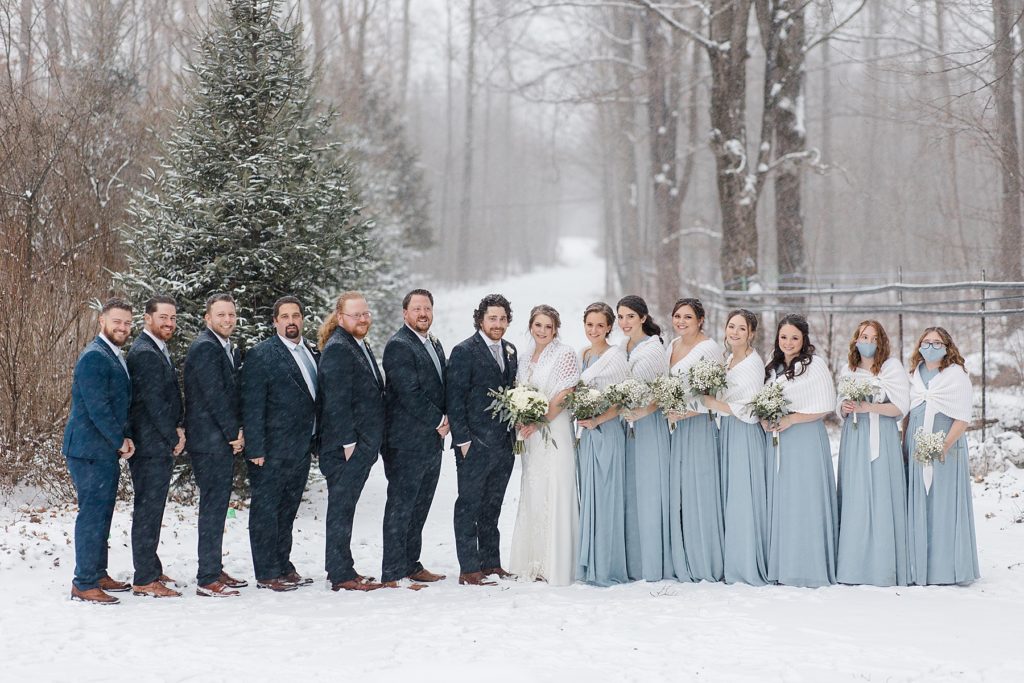 wedding party wearing navy and dusty blue for temples country winter wedding photographed by Brittany Navin Photography