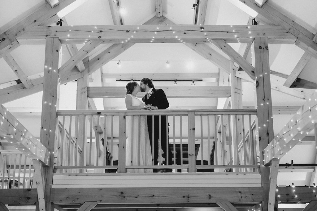 bride and groom up in the loft at temples country winter wedding photographed by Brittany Navin Photography