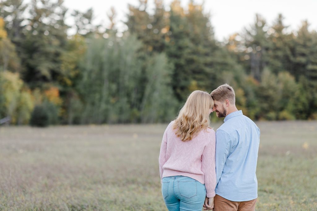 couple forehead to forehead facing away from the camera at Arnprior engagement session at Gillies Grove photographed by Brittany Navin Photography