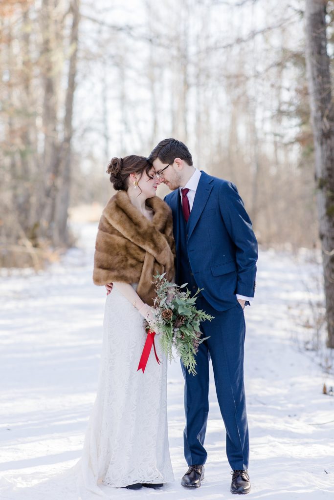 bride and groom forehead to forehead at Beckwith winter elopement photographed by Brittany Navin Photography