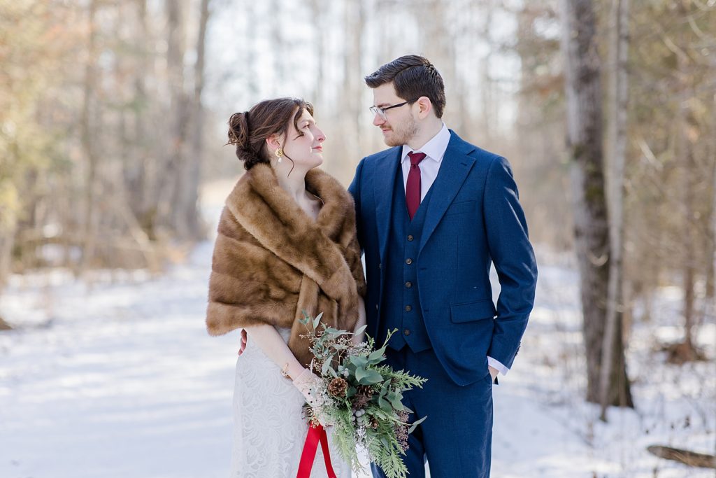 bride and groom looking at eachother at Beckwith winter elopement photographed by Brittany Navin Photography