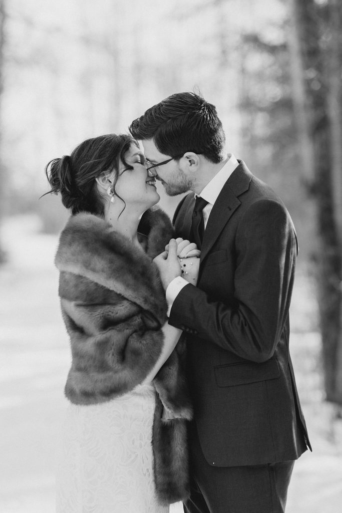 bride and groom about to kiss in black and white photo of Beckwith winter elopement photographed by Brittany Navin Photography