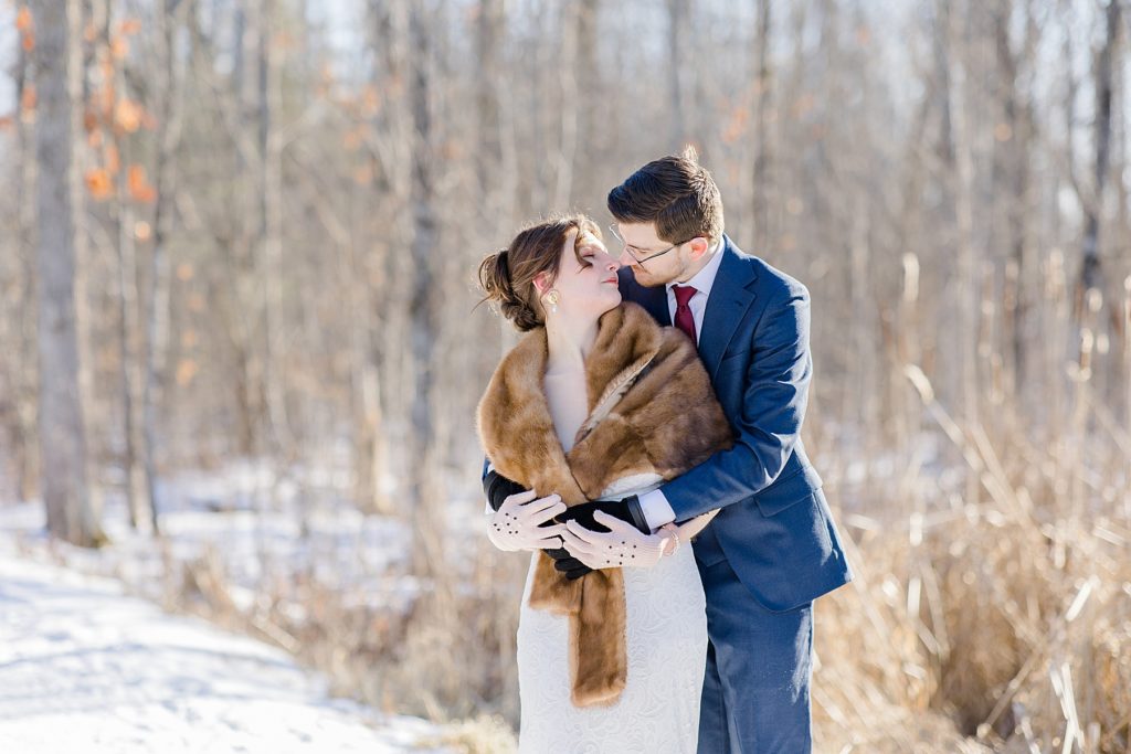 bride and groom hugging during portraits at Beckwith winter elopement photographed by Brittany Navin Photography