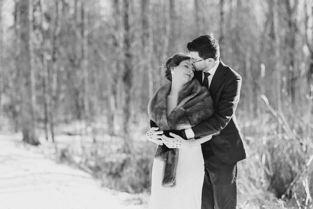 groom giving bride a forehead kiss at Beckwith winter elopement photographed by Brittany Navin Photography