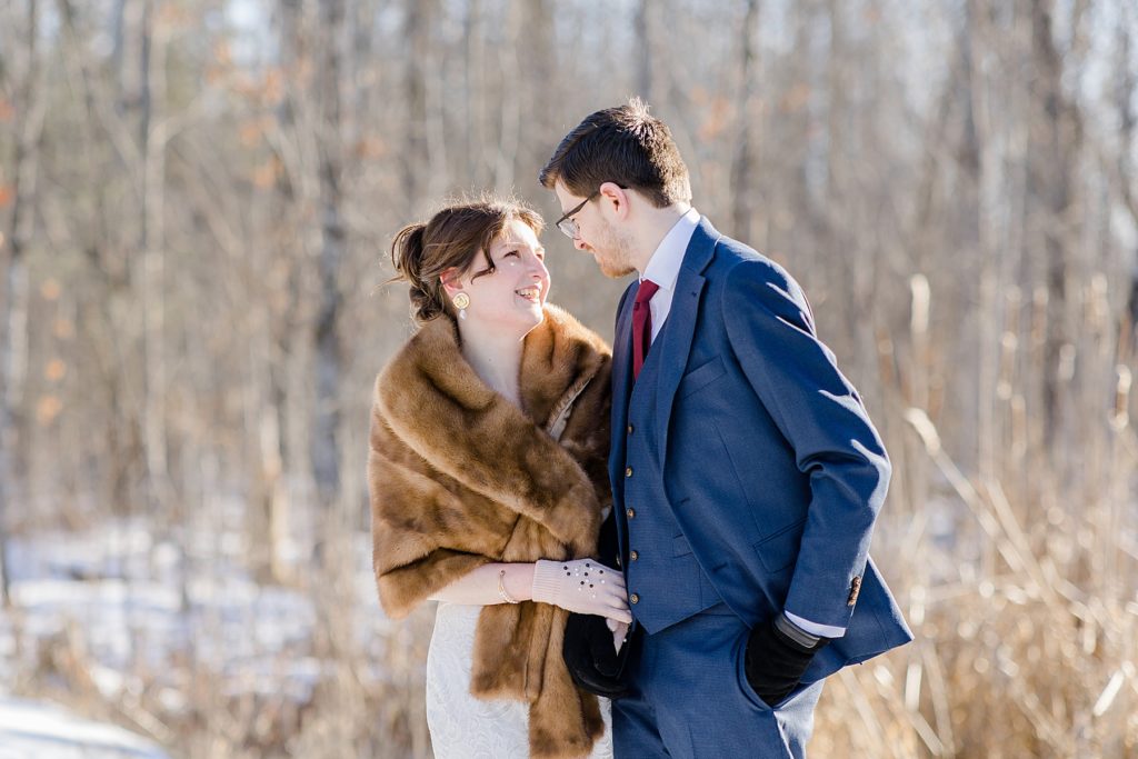 bride and groom looking at eachother during their portraits at Beckwith winter elopement photographed by Brittany Navin Photography