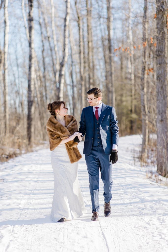 bride and groom walking down the Beckwith Trail at Beckwith winter elopement photographed by Brittany Navin Photography