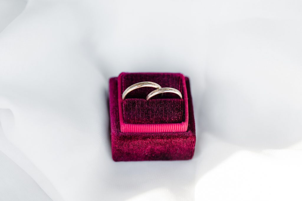 wedding bands placed inside of burgundy ring box for beckwith winter elopement