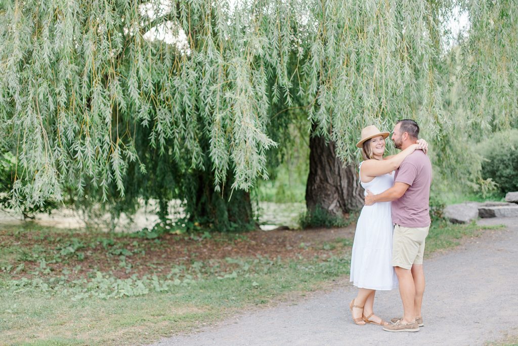 couple together near willow tree at dominion arboretum engagement session phtoographed by Brittany Navin Photography
