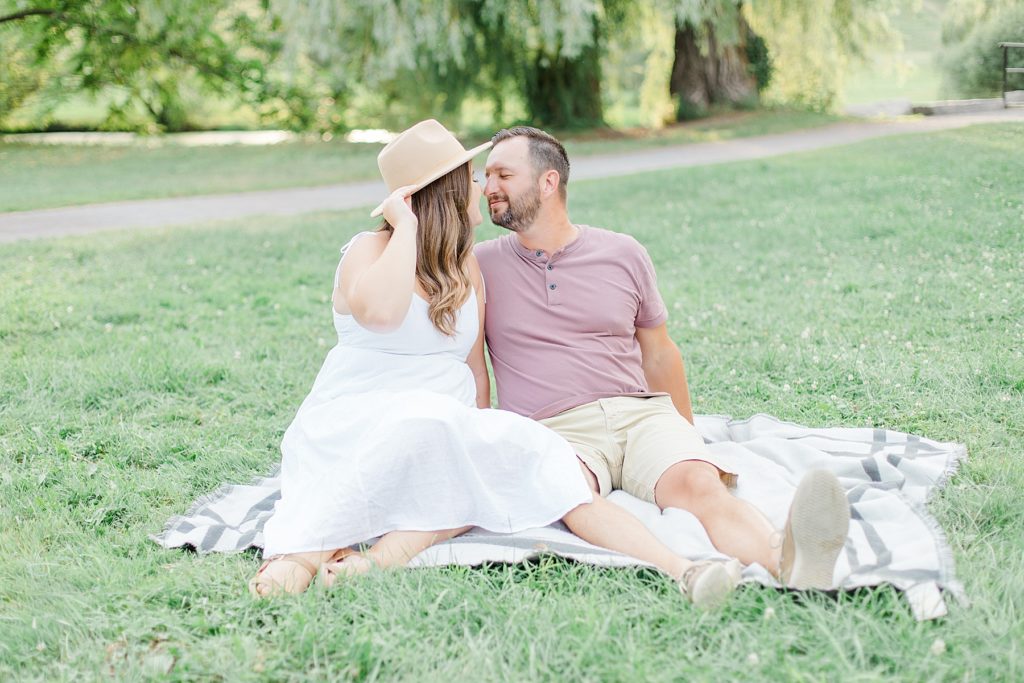 couple sitting on picnic blanket at dominion arboretum engagement session phtoographed by Brittany Navin Photography