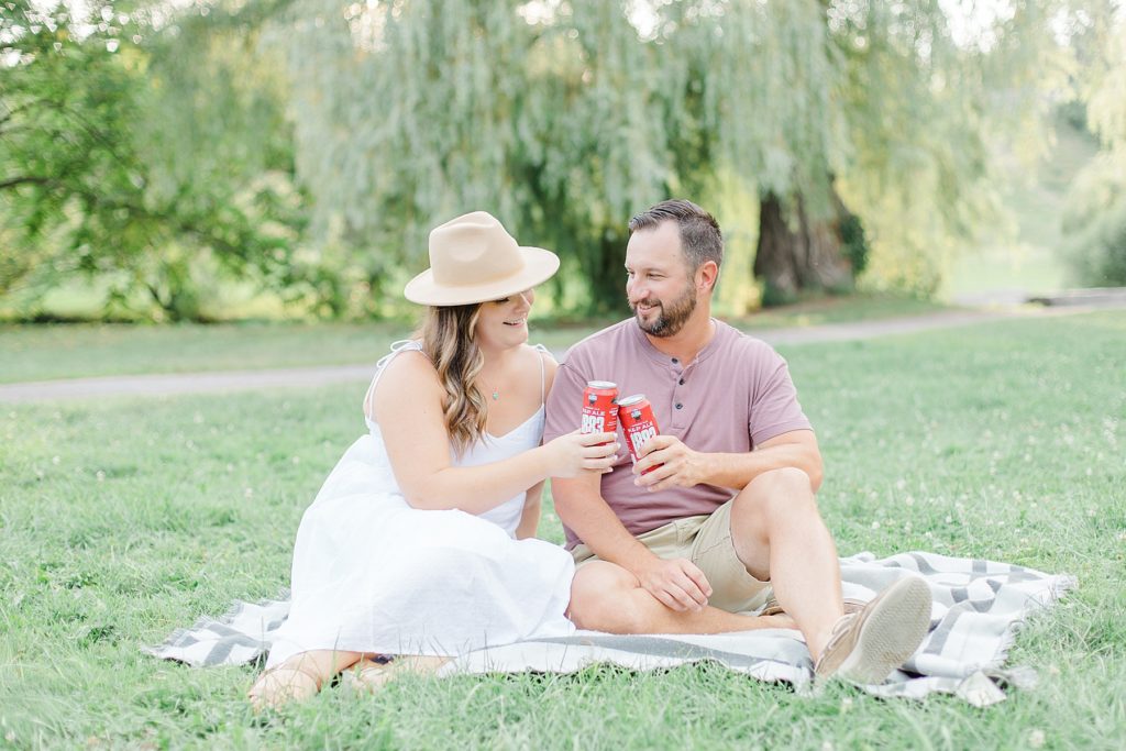 couple having picnic beers at dominion arboretum engagement session phtoographed by Brittany Navin Photography
