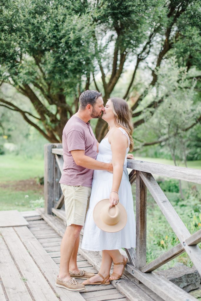 couple about to kiss on the brideg at dominion arboretum engagement session phtoographed by Brittany Navin Photography