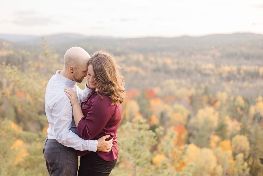 couple at top of cliff at eagle's nest fall engagement photographed by Brittany Navin Photography