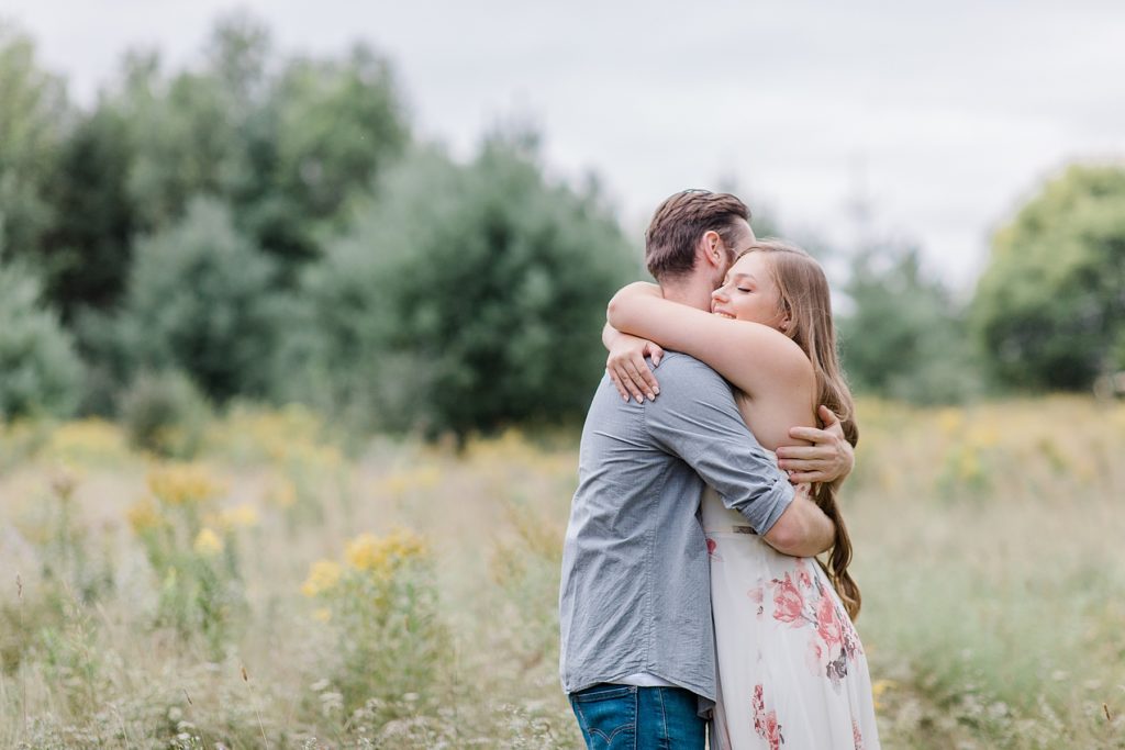couple hugging at mill of kintail engagement session photographed by Brittany Navin Photography