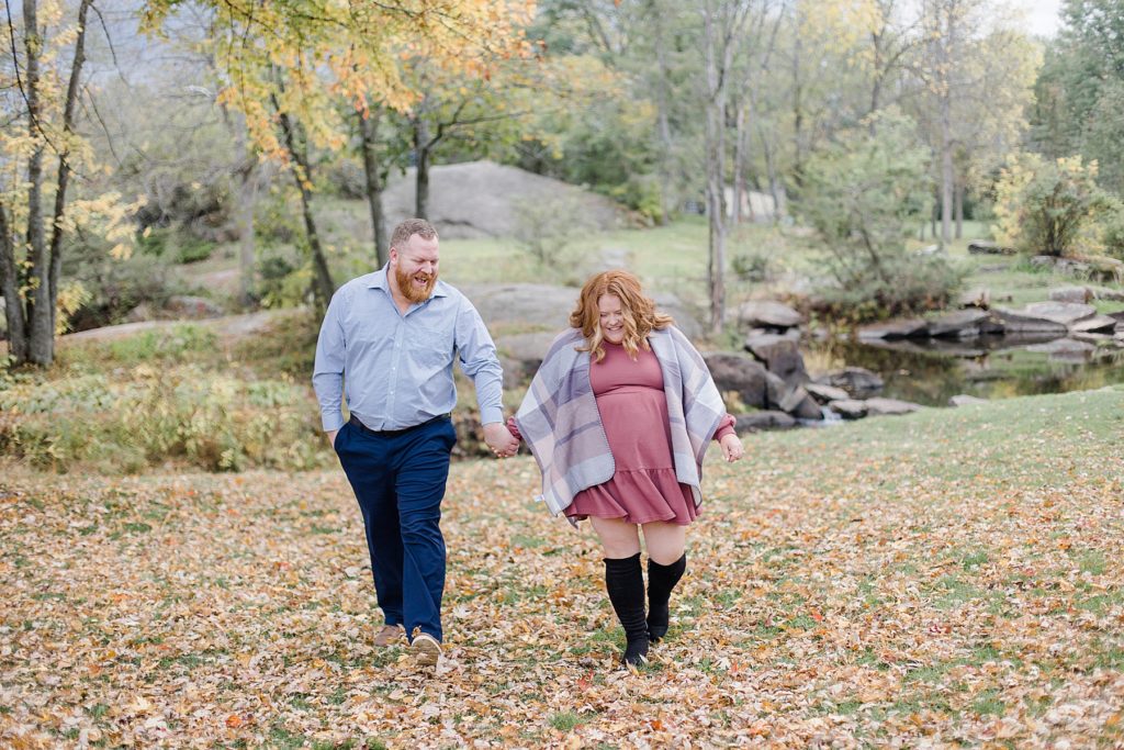 couple walking and holding hands At Stewart Park Engagement photographed by Brittany Navin Photography