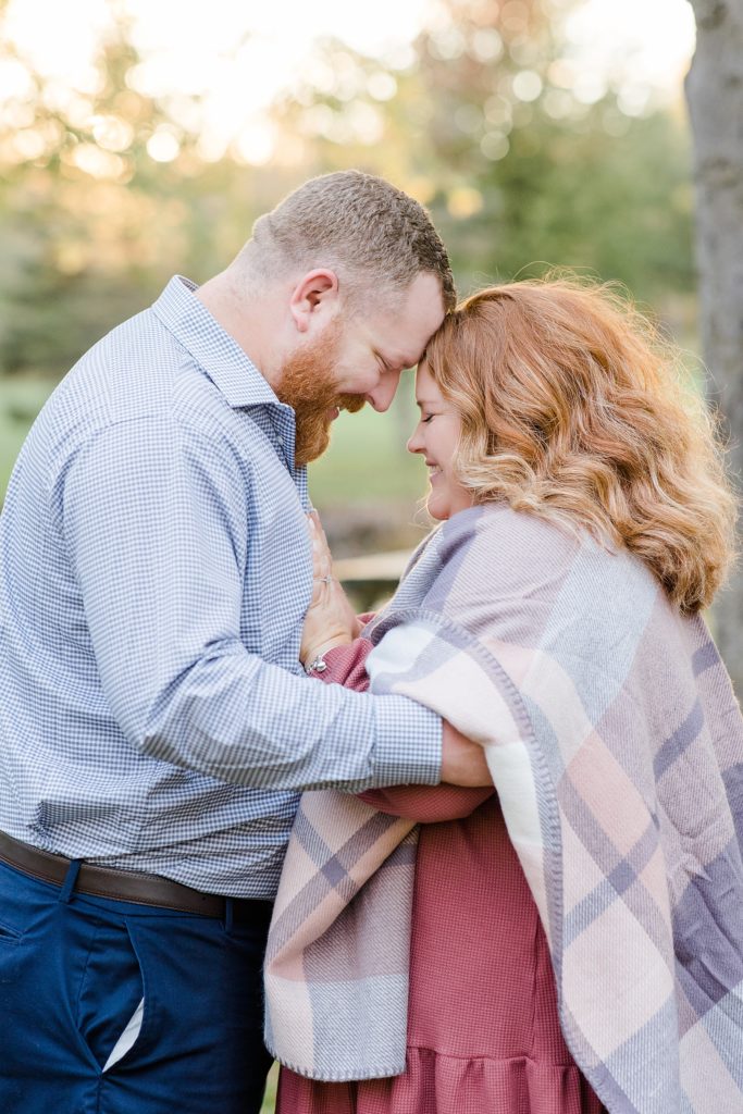 couple forehead to forehead At Stewart Park Engagement photographed by Brittany Navin Photography