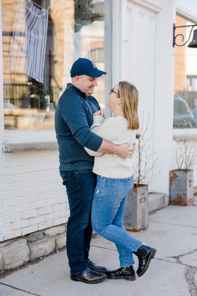 couple standing outside of shop at Downtown Almonte Engagement Session photographed by Brittany Navin Photography