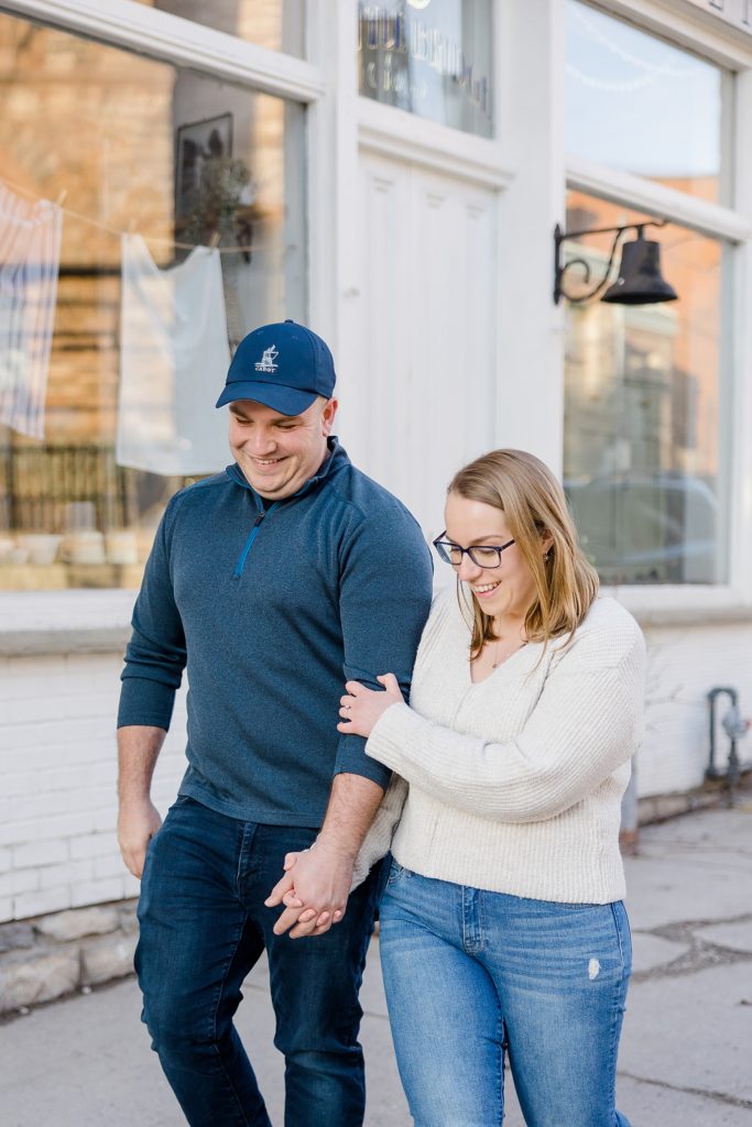 couple walking in front of tin barn market at Downtown Almonte Engagement Session photographed by Brittany Navin Photography