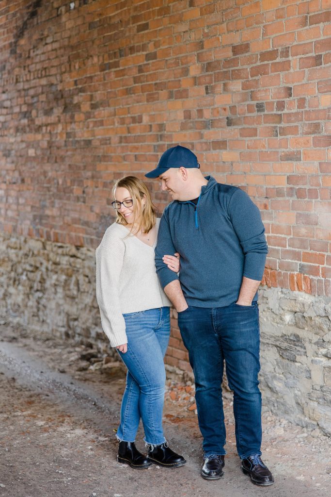 couple in alley at Downtown Almonte Engagement Session photographed by Brittany Navin Photography