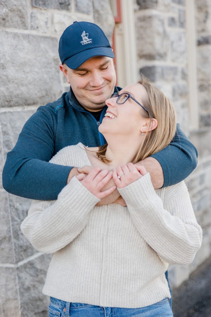 couple laughing together at Downtown Almonte Engagement Session photographed by Brittany Navin Photography