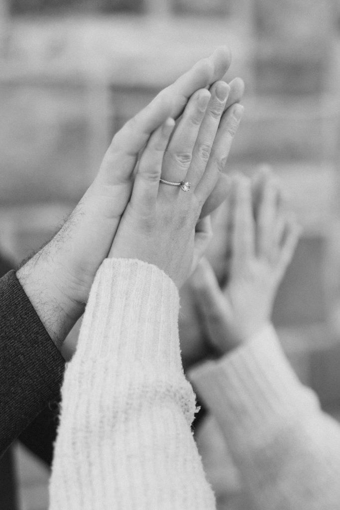 close up of hands in black and white at Downtown Almonte Engagement Session photographed by Brittany Navin Photography