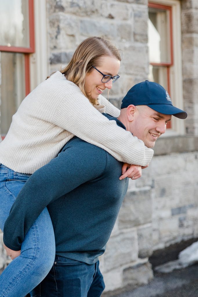 piggy back ride at Downtown Almonte Engagement Session photographed by Brittany Navin Photography