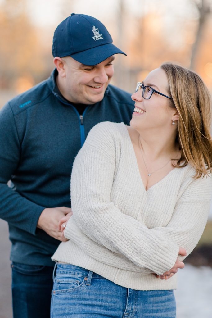 he has her wrapped up at Downtown Almonte Engagement Session photographed by Brittany Navin Photography
