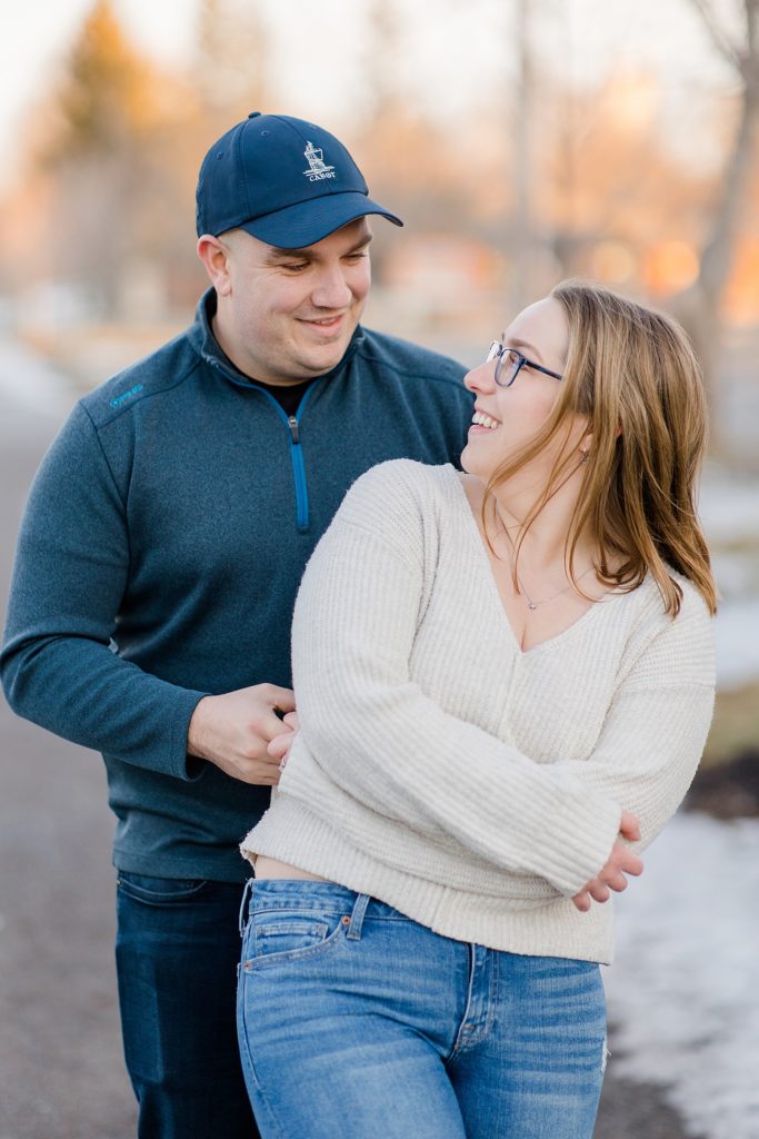 couple laughing together at Downtown Almonte Engagement Session photographed by Brittany Navin Photography
