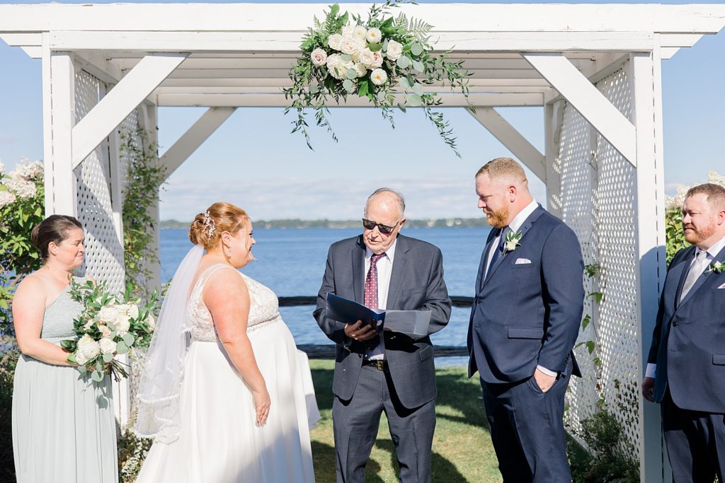 waterside wedding ceremony at calabogie peaks summer wedding photographed by Brittany Navin Photography