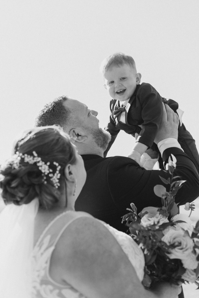 bride and groom with their son at calabogie peaks summer wedding photographed by Brittany Navin Photography