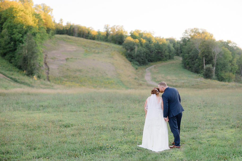 bride and groom portrait by ski hill at calabogie peaks summer wedding photographed by Brittany Navin Photography