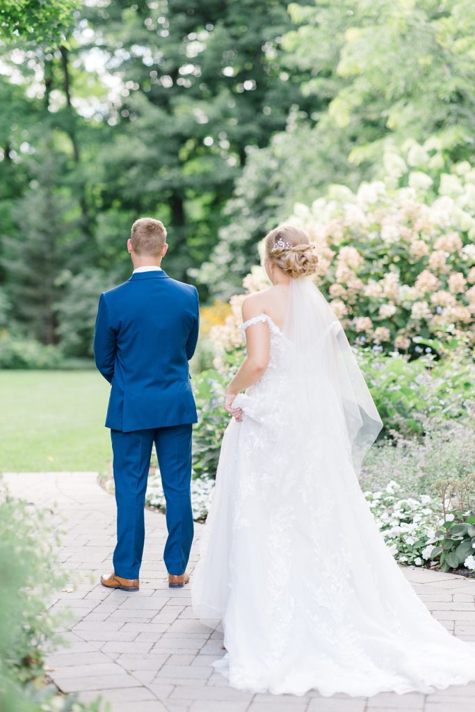 First look between bride and groom in garden of Temple's Country Wedding photographed by Brittany Navin Photography 