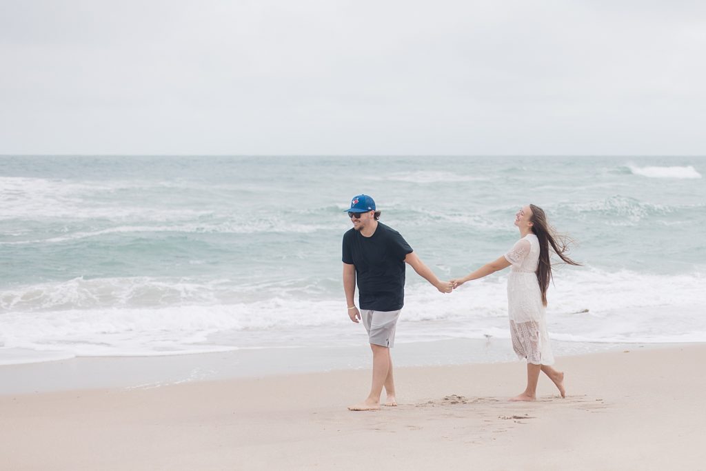 couple walking along the shore edge of Melbourne Beach, Florida Photographed by Brittany Navin Photography an Ottawa Based Destination Wedding Photographer