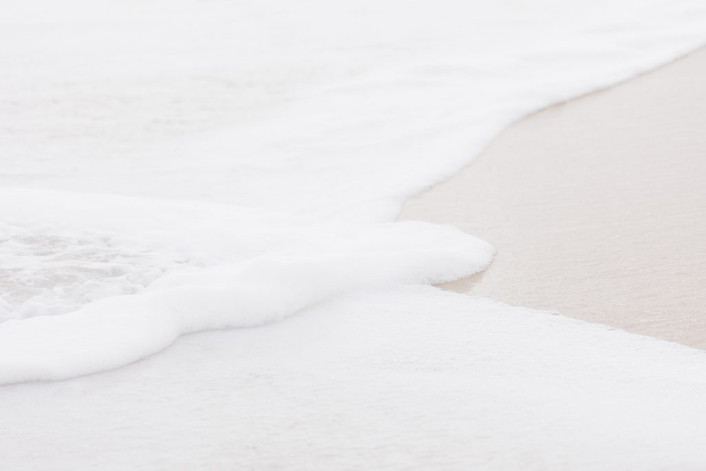 photo of the ocean foam hitting the sand at Melbourne Beach, Florida Photographed by Brittany Navin Photography an Ottawa Based Destination Wedding Photographer