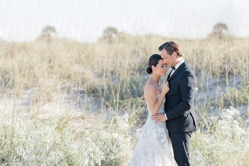 husband and wife portraits in the sand dunes at the coastal opulence beach wedding editorial photographed by Brittany Navin Photography