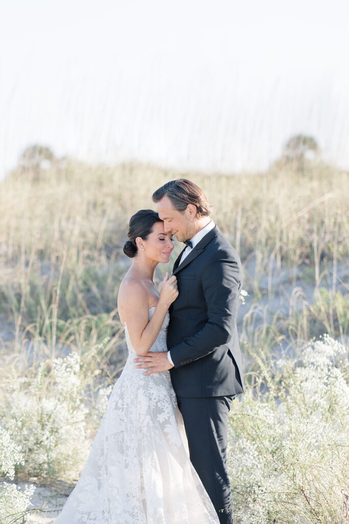 bride and groom portrait in the sand dunes at Omni Amelia Island Resort photographed by Brittany Navin Photography