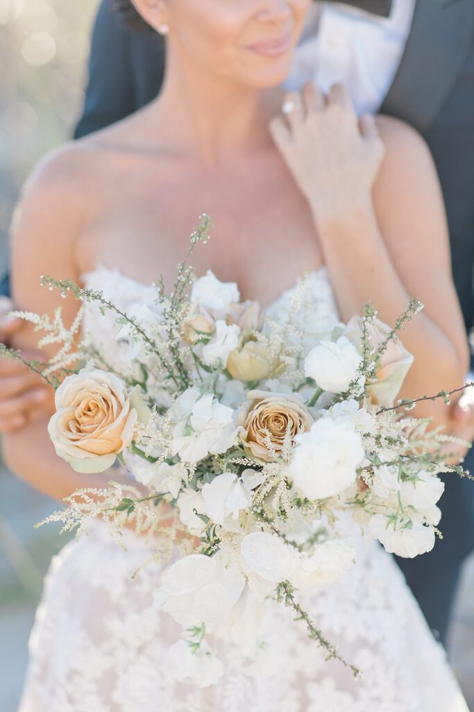 Detail image of neutral bridal bouquet from the Flower Bar Co. at the coastal opulence beach wedding editorial photographed by Brittany Navin Photography