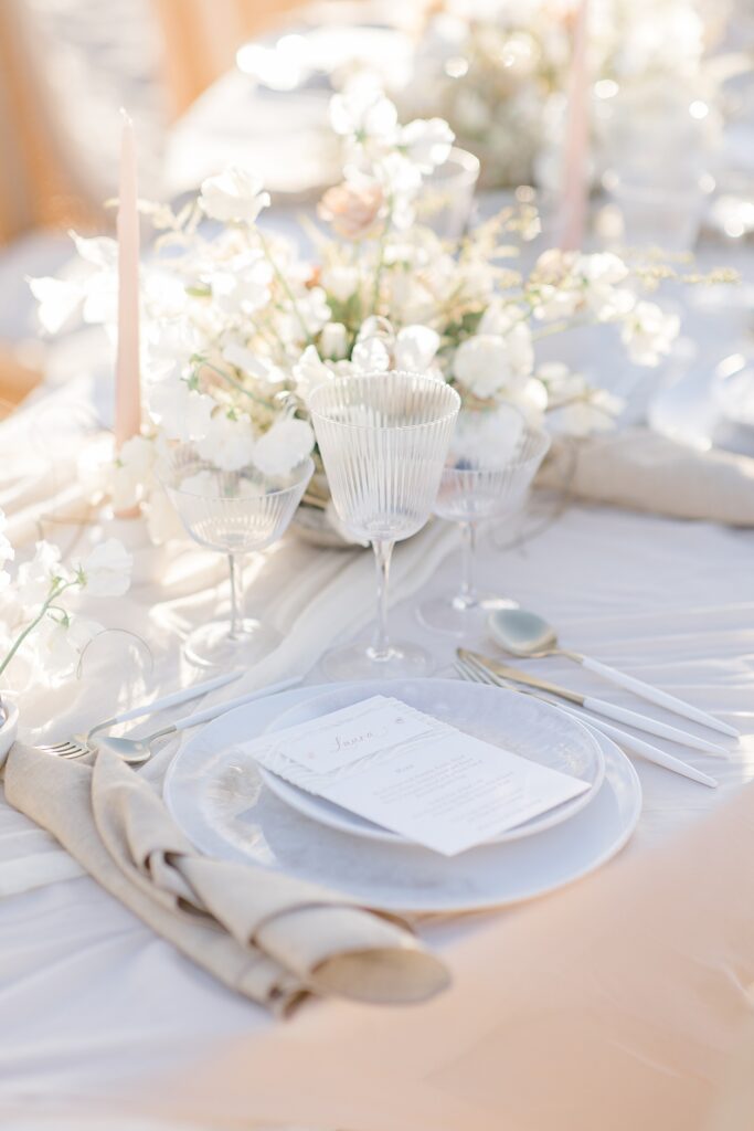 light and neutral tablescape for a beach reception at the coastal opulence beach wedding editorial photographed by Brittany Navin Photography