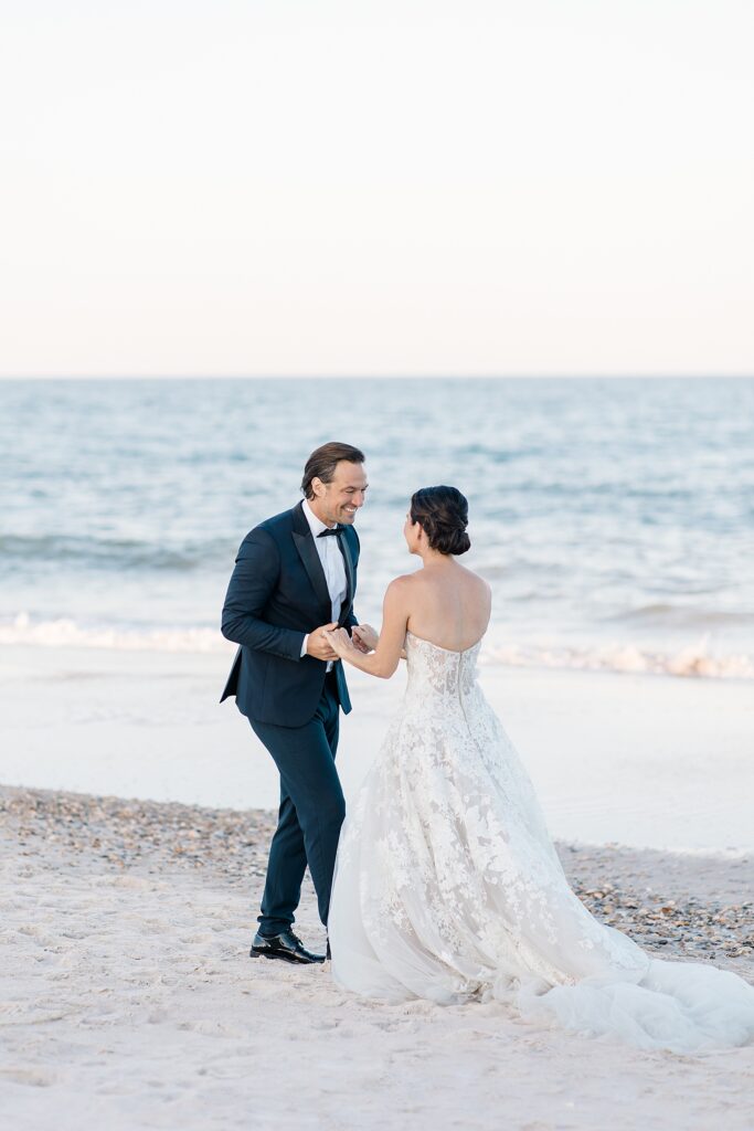 bride and groom looking at eachother in excitement as they realize they are officially husband and wife at destination wedding on the Atlantic ocean photographed by Brittany Navin Photography