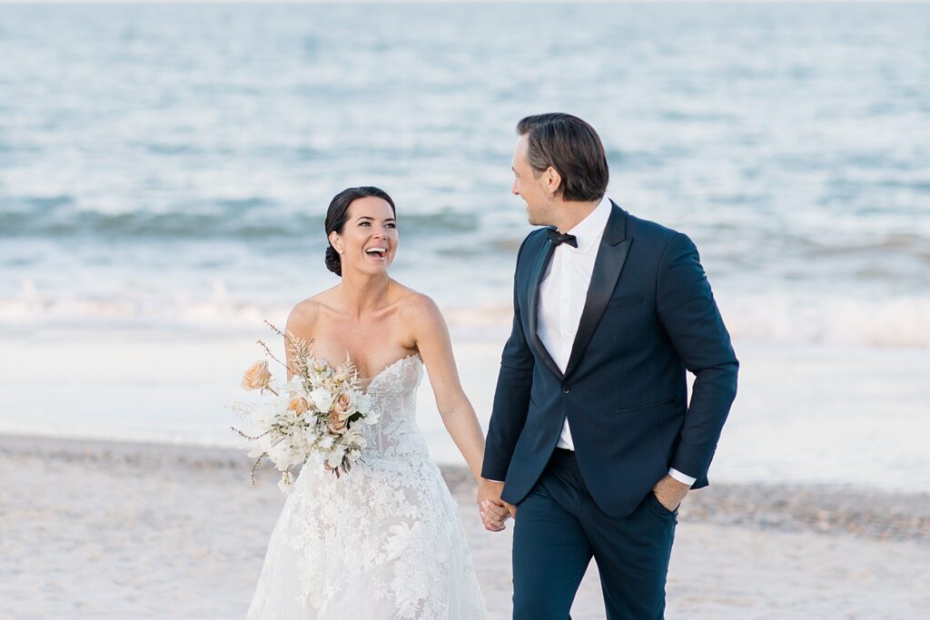 joyful bride and groom at the coastal opulence beach wedding editorial photographed by Brittany Navin Photography
