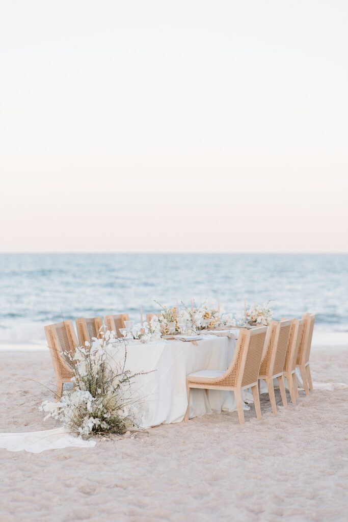 light and neutral wedding reception table scape at the coastal opulence beach wedding editorial photographed by Brittany Navin Photography