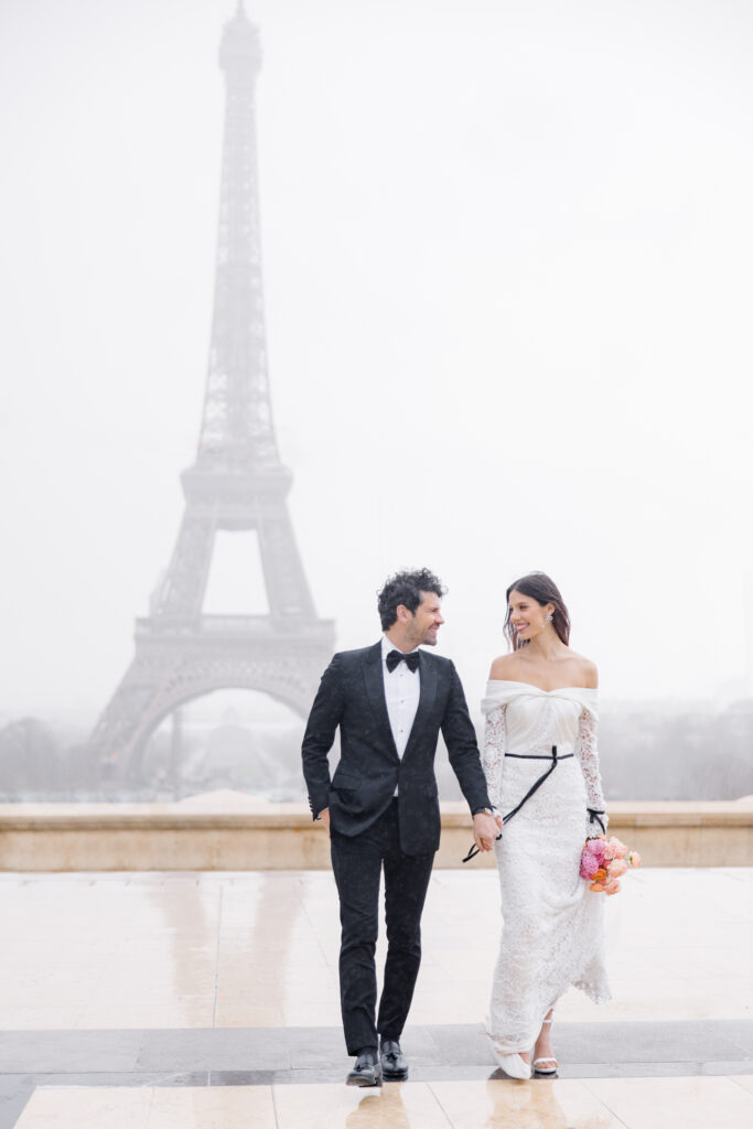 bride and groom walking in front of the Eiffel Tower during elopement editorial in Paris, France, photographed by Brittany Navin Photography, an Ottawa based destination wedding photographer.