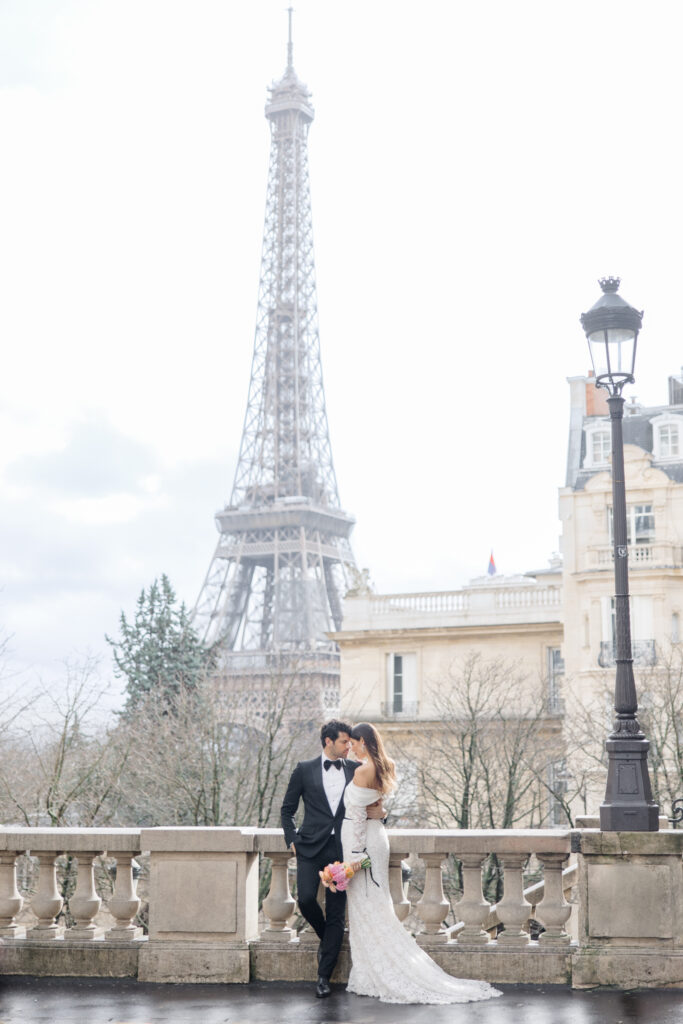 Bride and groom sharing private moment overlooking Eiffel Tower at elopement editorial in Paris, France, photographed by Brittany Navin Photography, an Ottawa based destination wedding photographer.