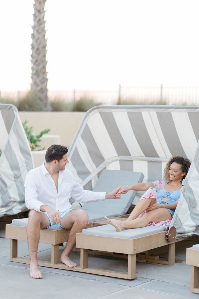couple lounging in the pool cabanas at Amelia Island Honeymoon Session photographed by Brittany Navin Photography 